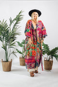 a woman in a hat and colorful robe