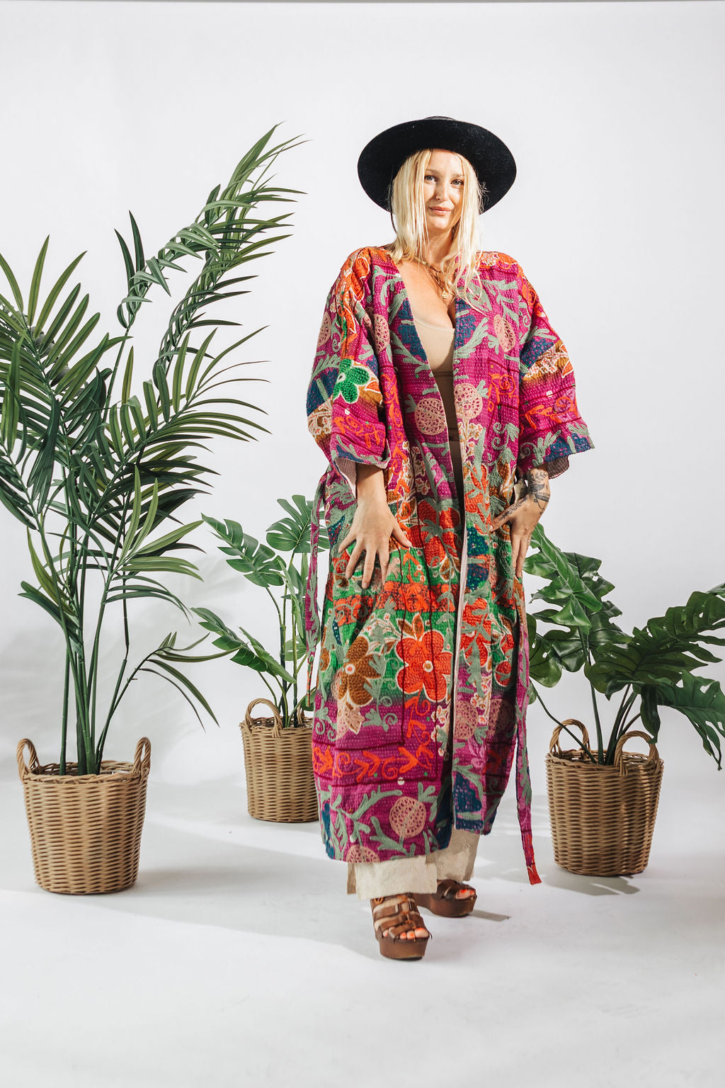 a woman in a hat and colorful robe