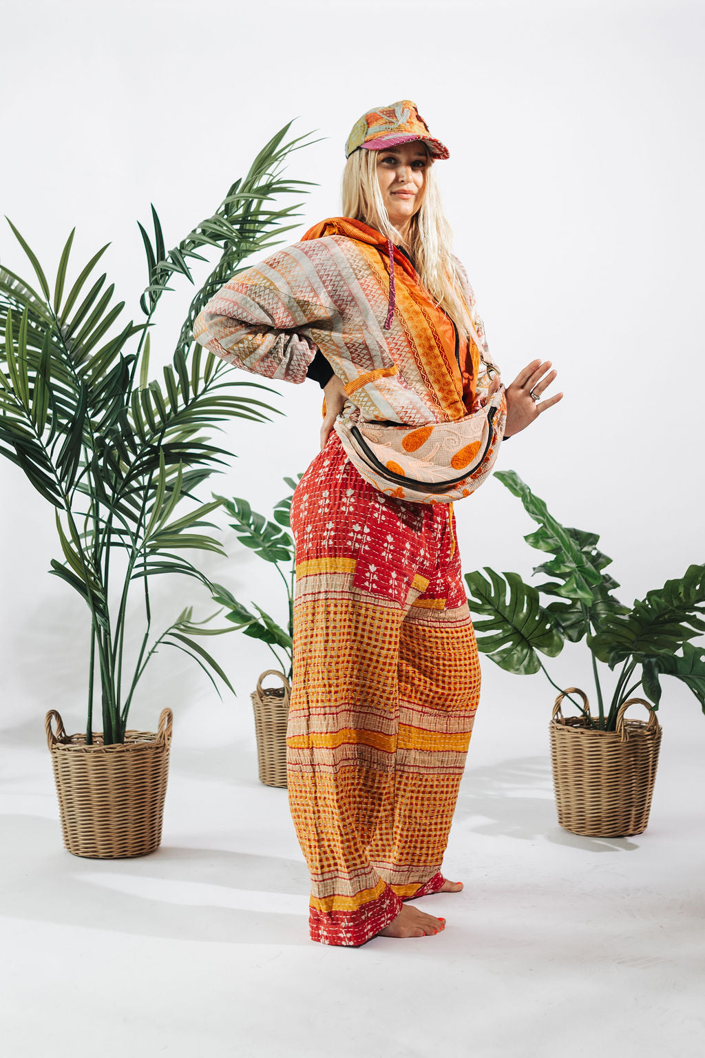 a woman standing in front of plants