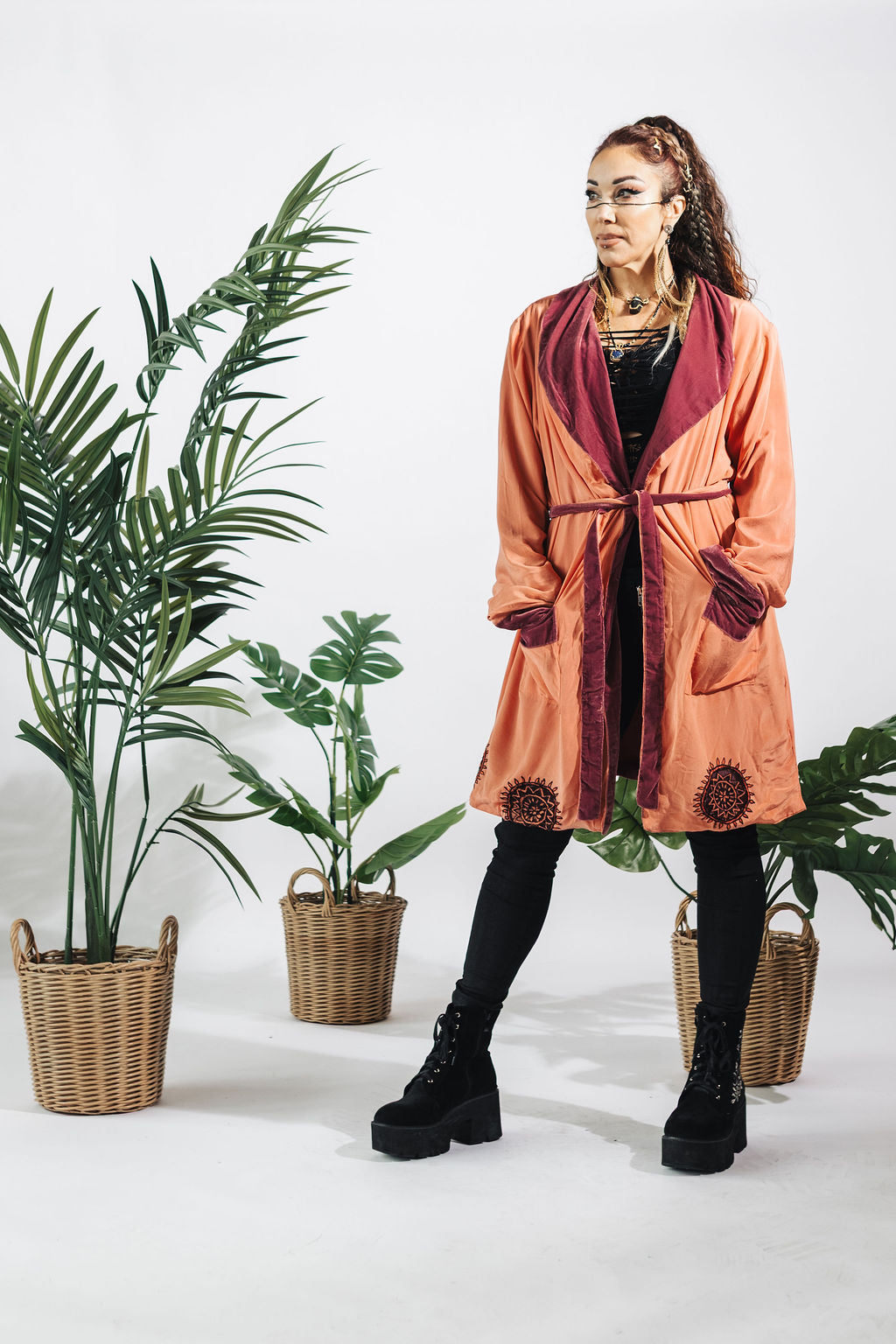 a woman standing next to plants
