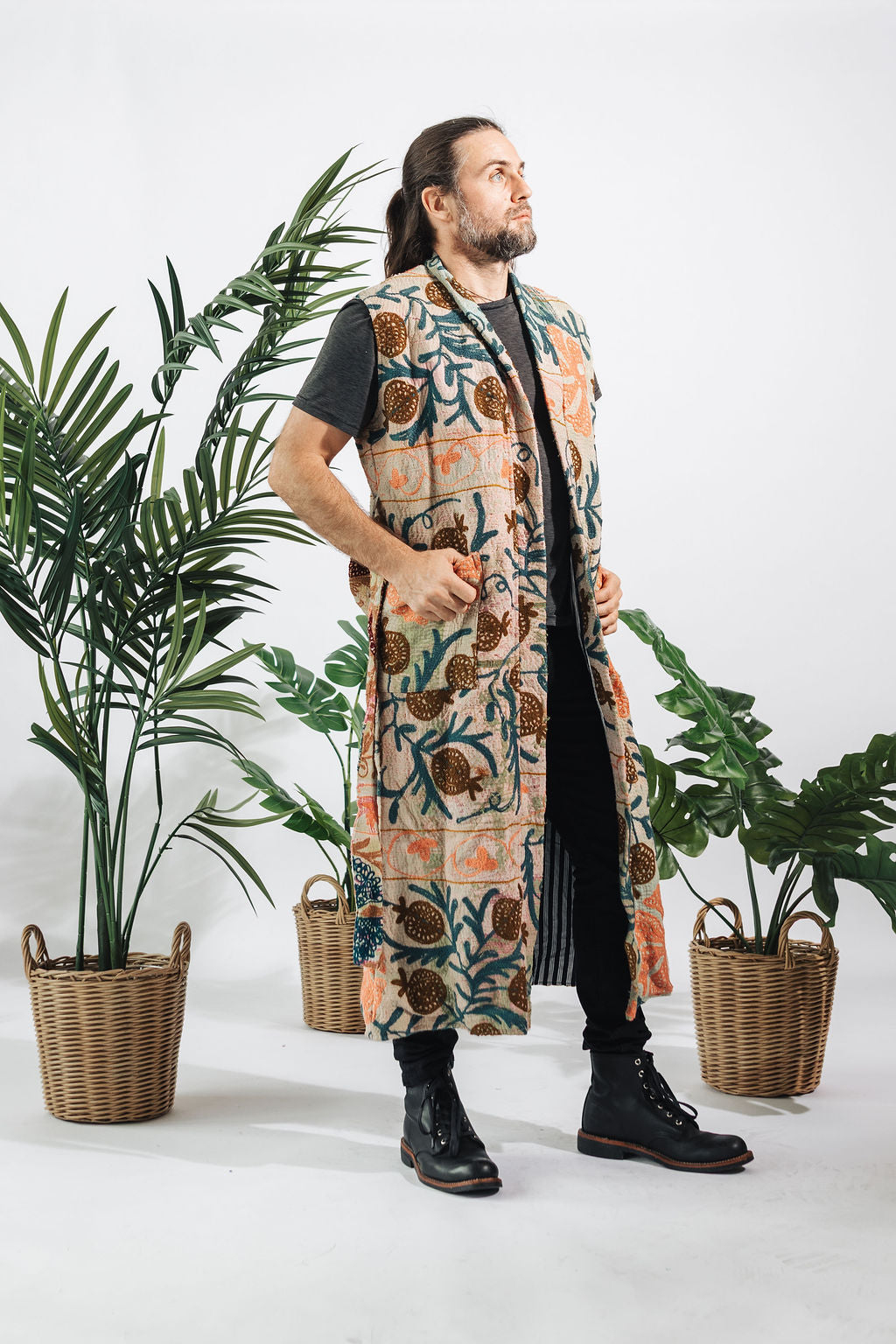 a man standing in front of plants