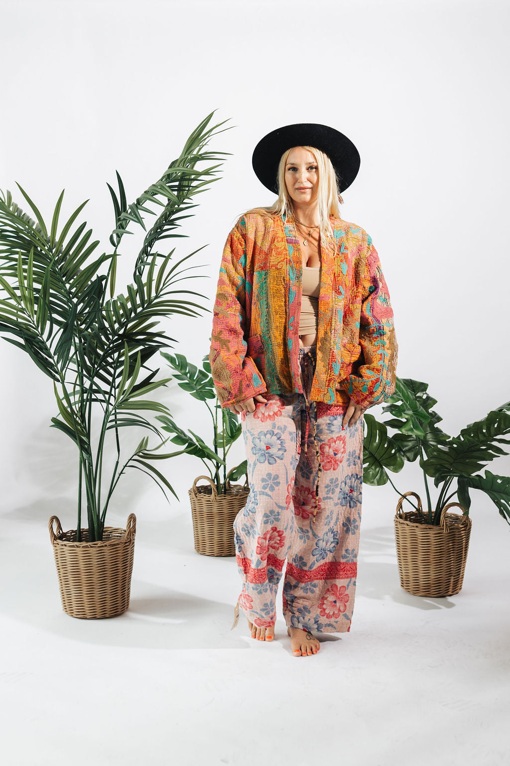 a woman standing in front of plants