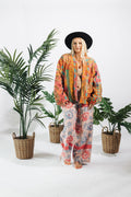 a woman standing in front of plants