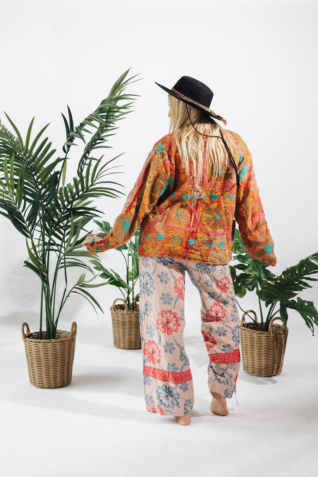 a woman wearing a hat and pants