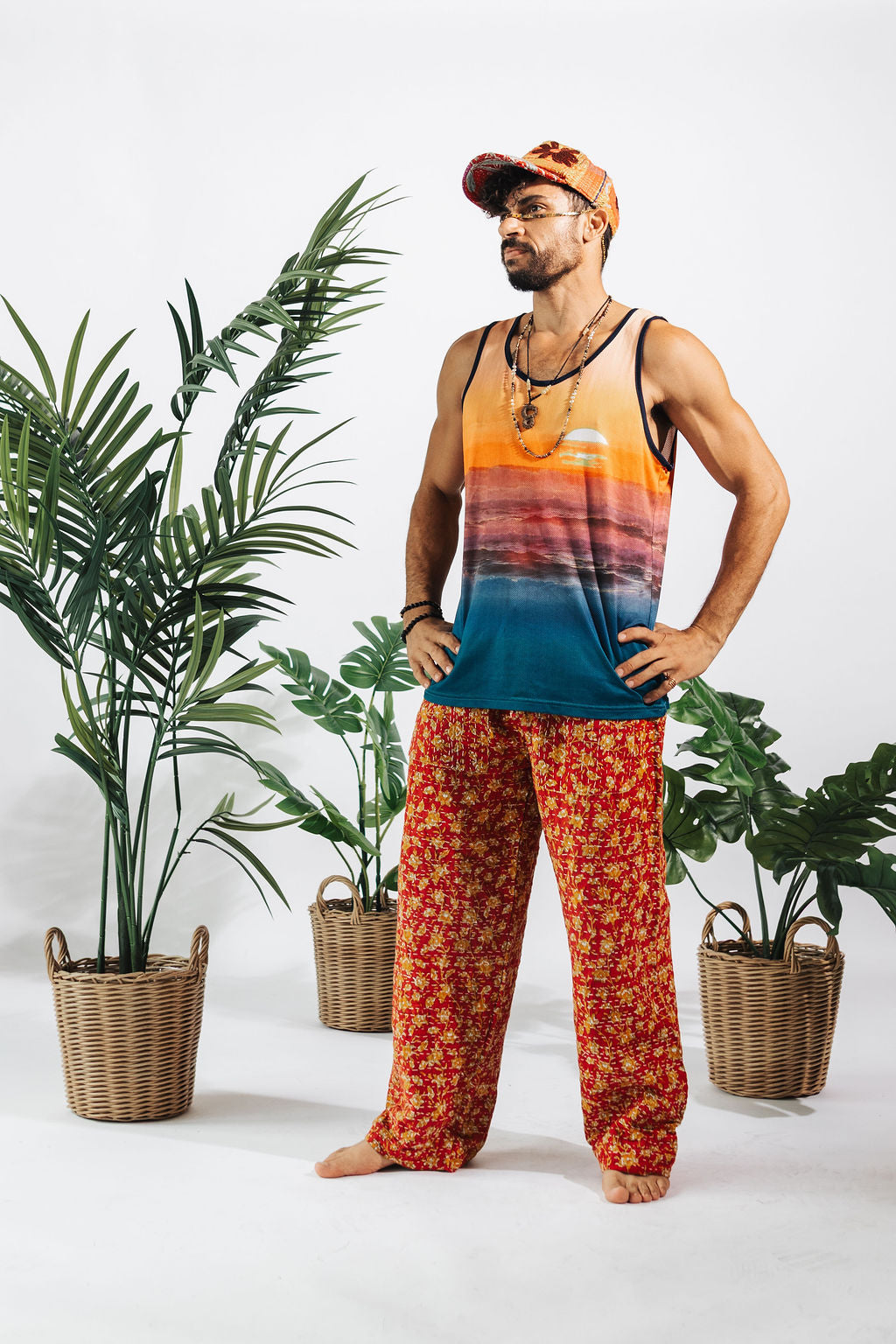 a man in colorful pants and a tank top