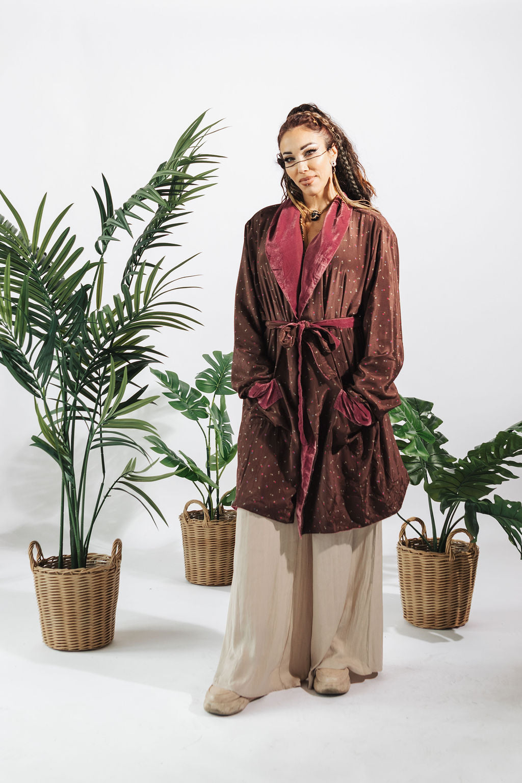 a woman standing in front of two baskets of plants
