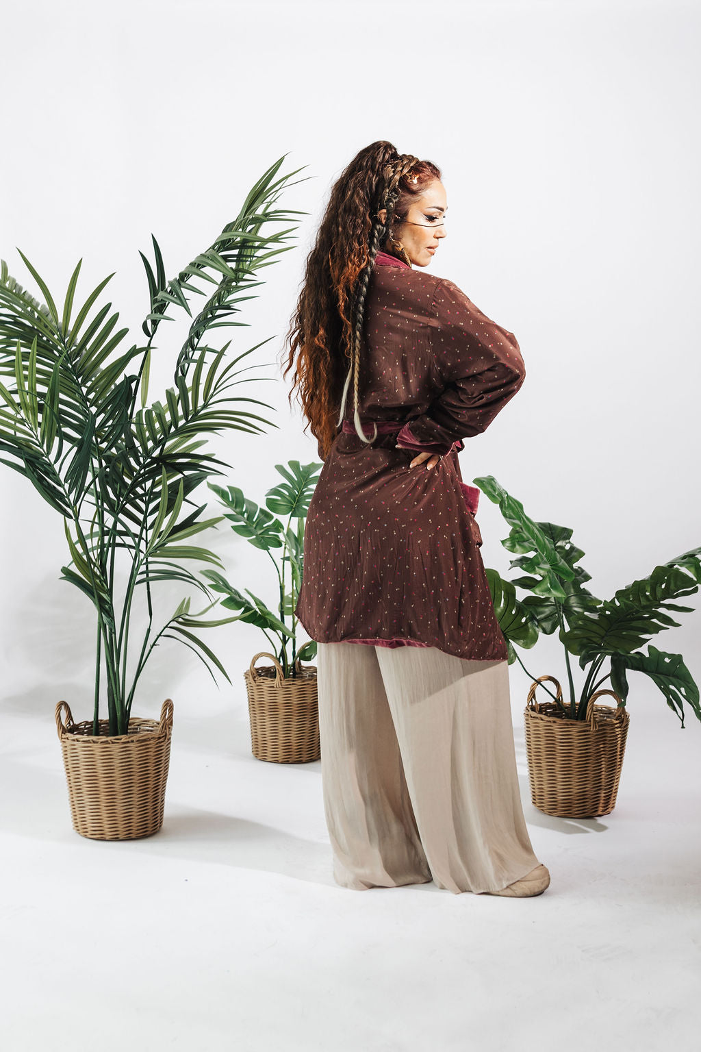 a woman standing in front of plants