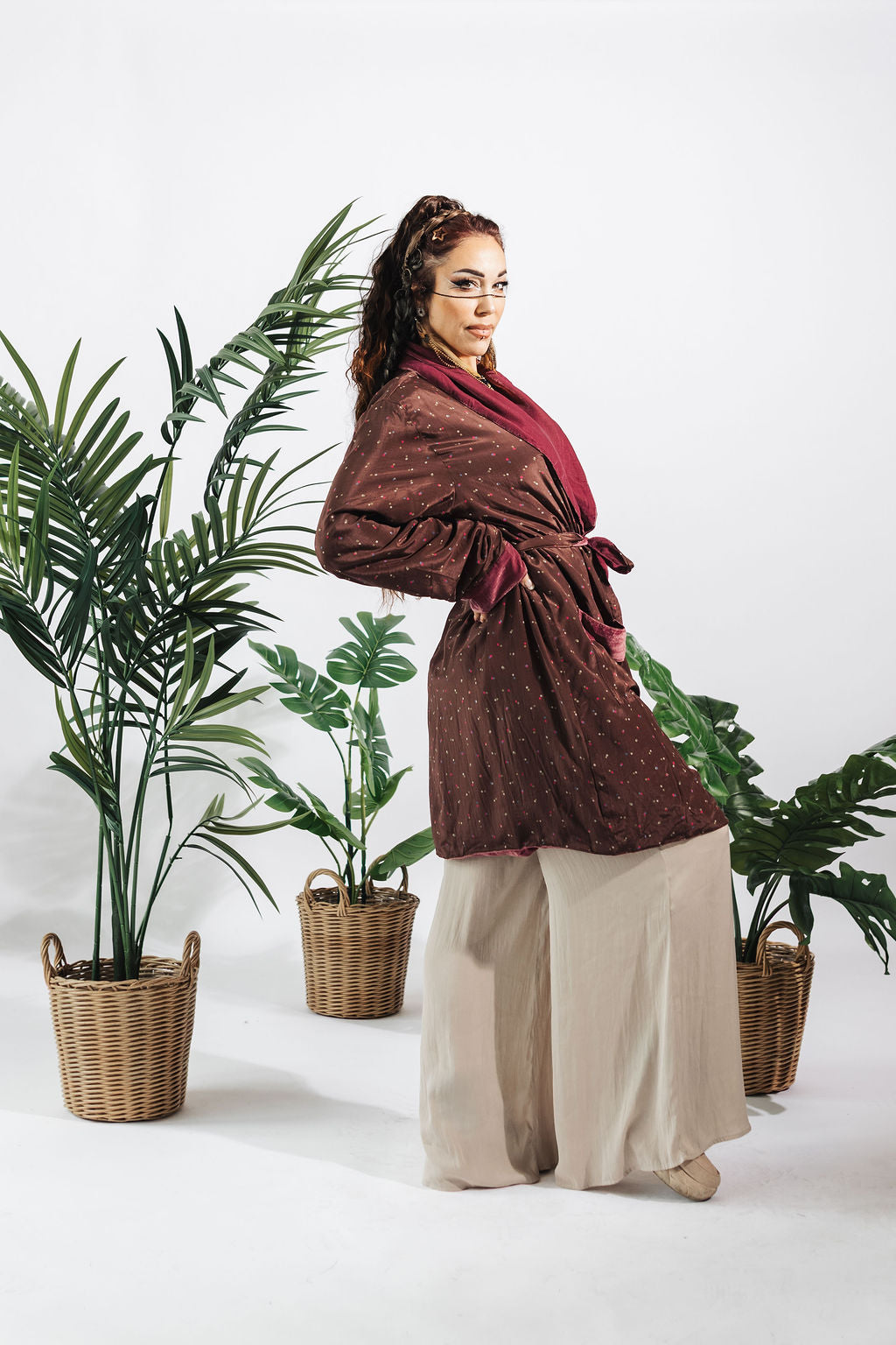a woman standing in front of plants