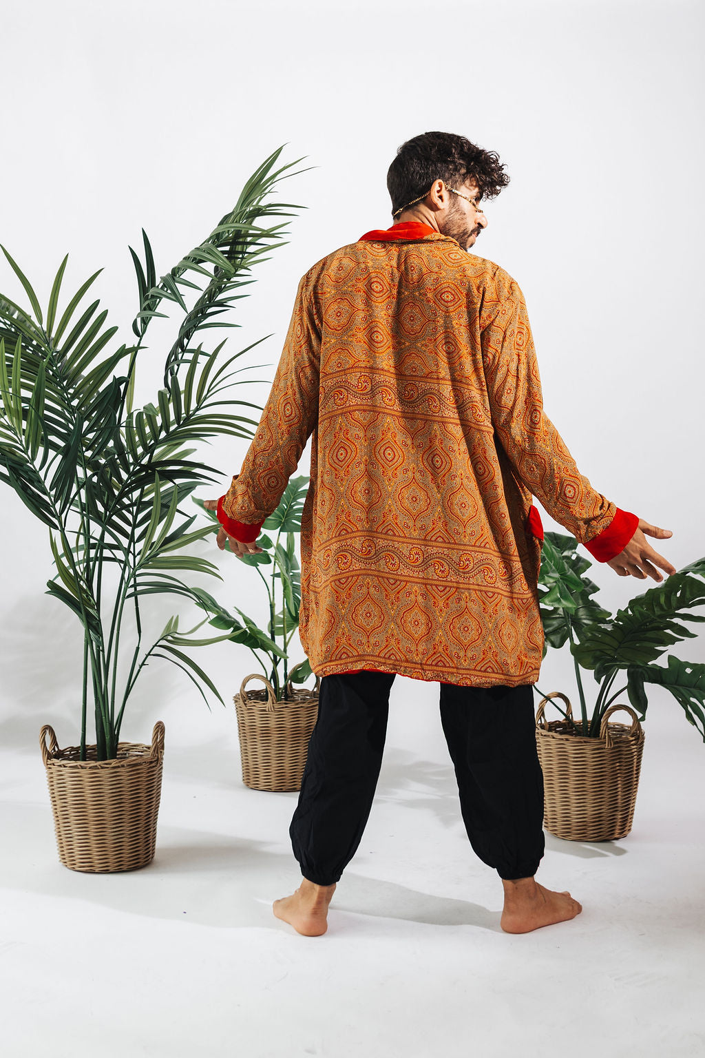 a man in a robe and black pants
