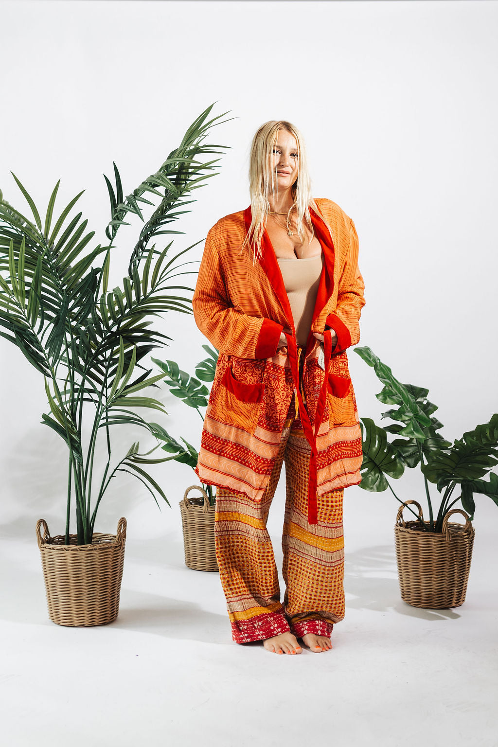 a woman standing in front of plants
