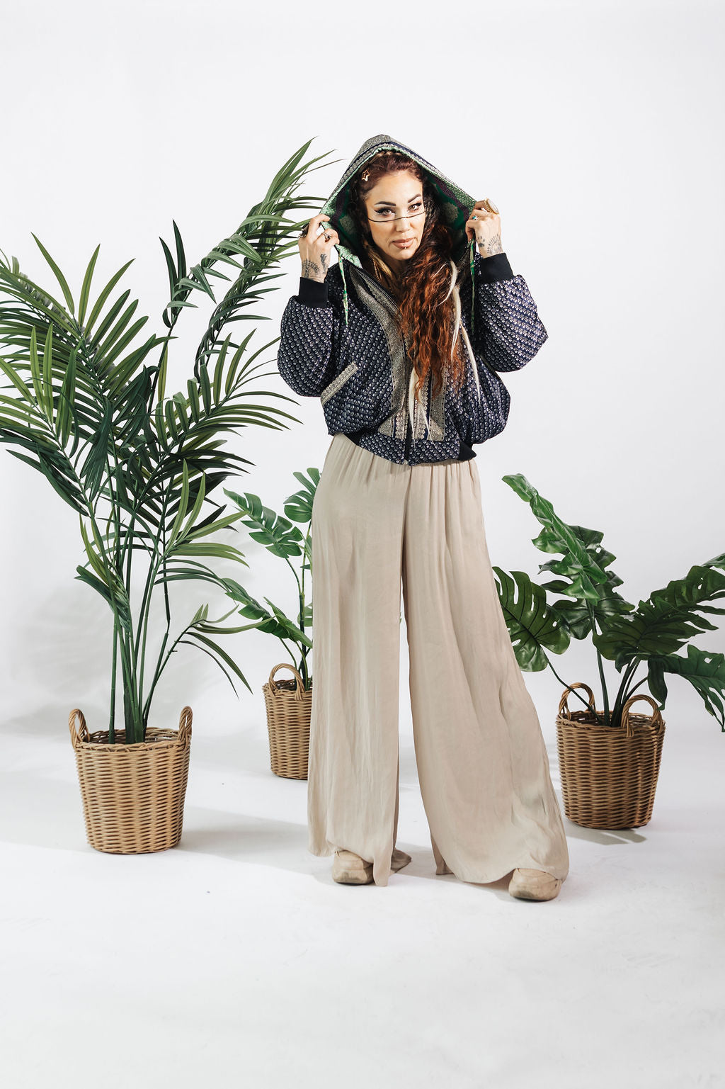 a woman standing in front of plants