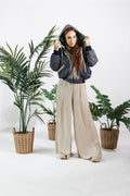a woman standing in front of plants