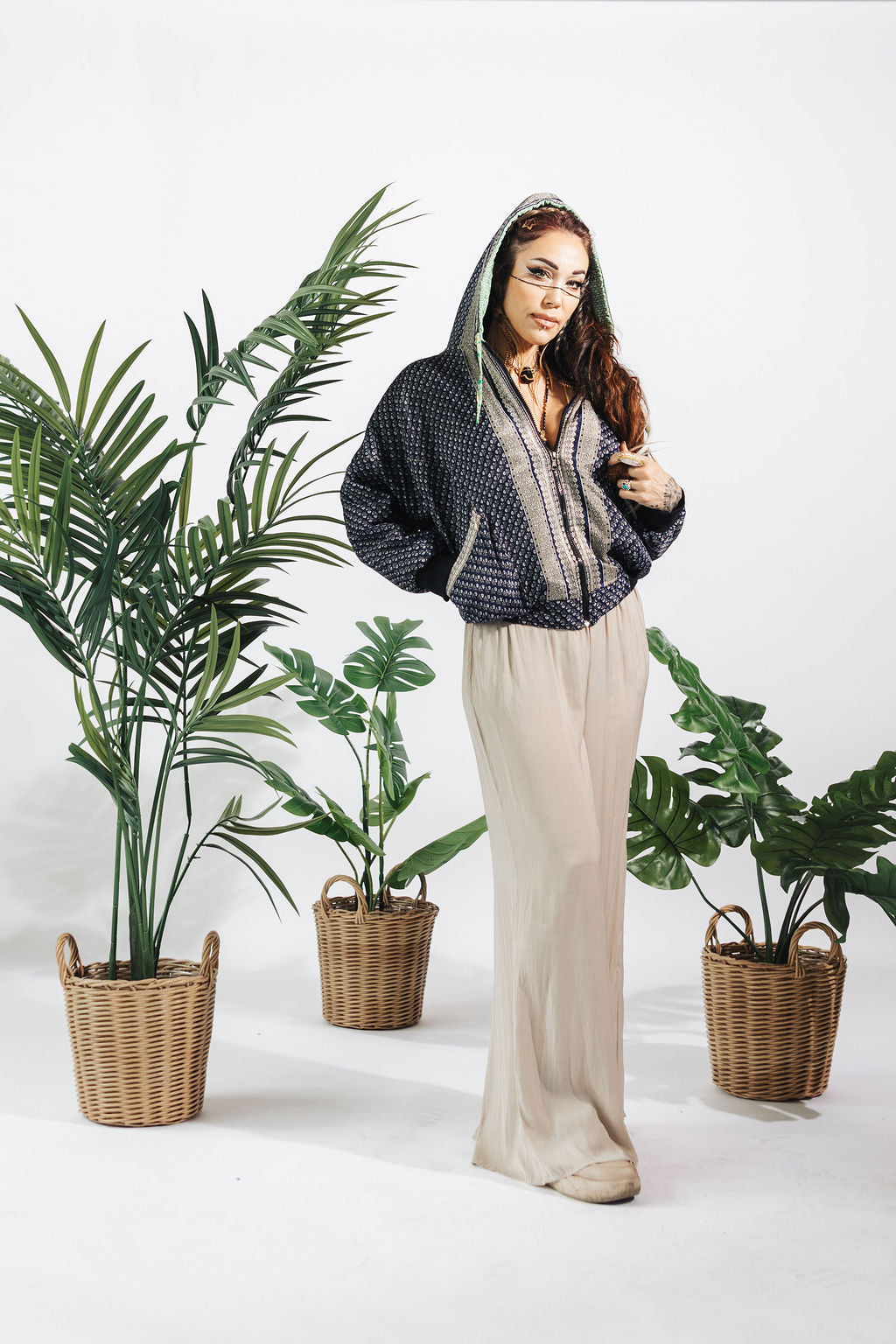 a woman standing next to plants