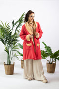 a woman standing in front of plants