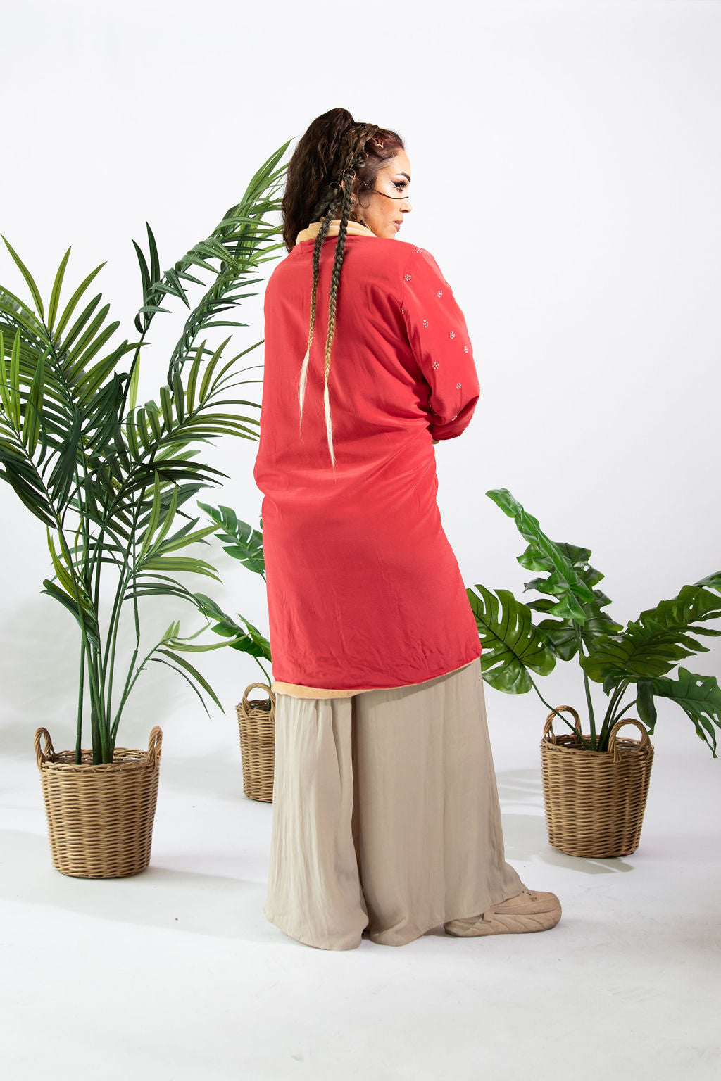a woman standing in front of plants