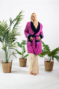 a woman standing in front of plants